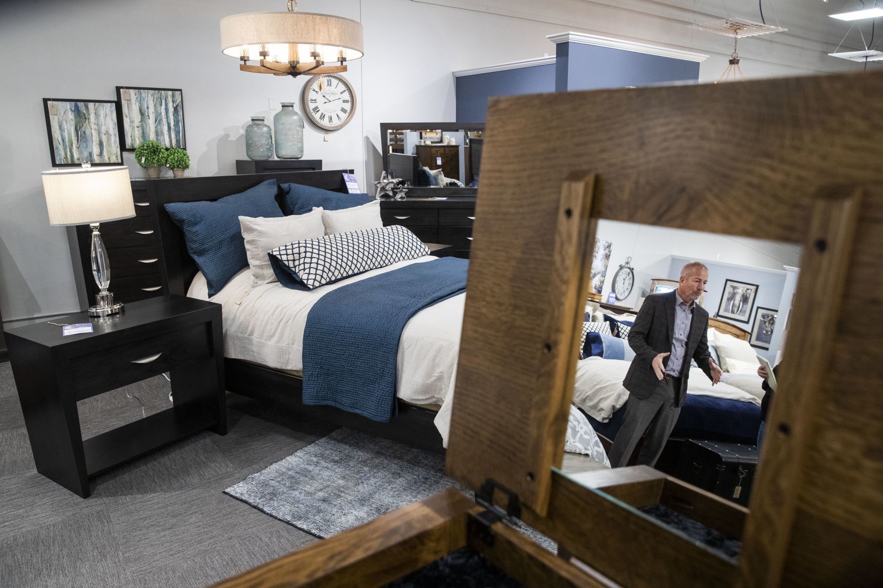 David Triplett showcases one of Amish Furniture of Nebraska's bedroom sets during a tour.